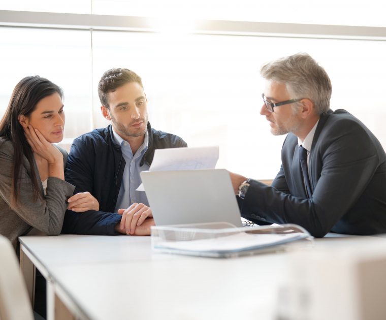 couple speaking to financial advisor to look at their cryptocurrency investments